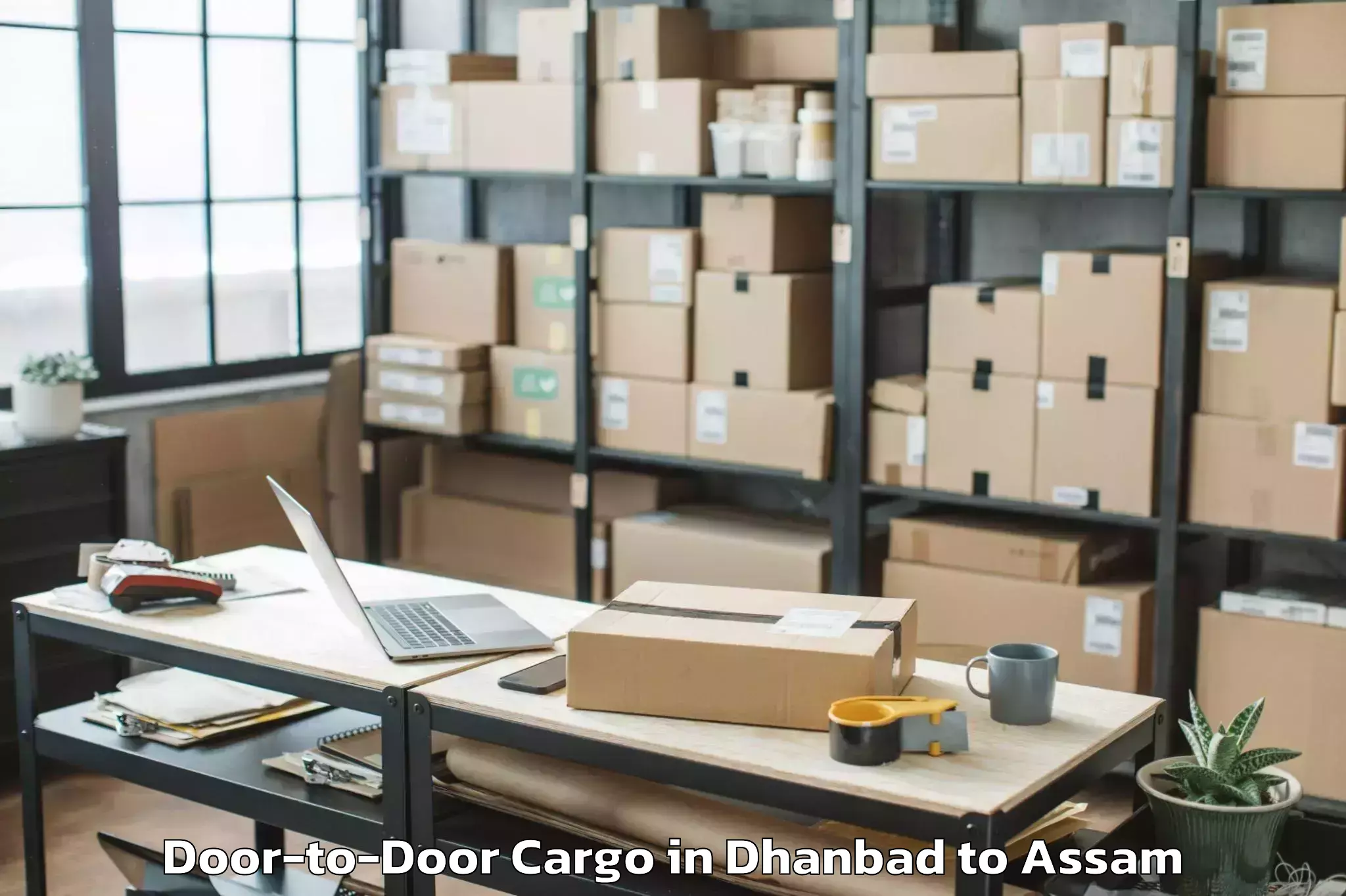 Leading Dhanbad to Sarupeta Pt Door To Door Cargo Provider